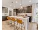 Kitchen island with breakfast bar seating offers stainless appliances, hardwood cabinets, and modern pendant lighting at 2001 Regal Dr # 89, Durham, NC 27703