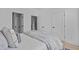 Bright bedroom features neutral tones, a comfortable bed with ample pillows, and modern interior doors at 2002 Moody Ln, Durham, NC 27701