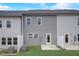 Backyard view of the townhouse features a patio and an outdoor grass area with a privacy fence at 2003 Regal Dr # 90, Durham, NC 27703