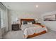 Well-lit bedroom with a cozy bed, side tables, and stylish decorative wallpaper at 2003 Regal Dr # 90, Durham, NC 27703