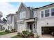 Charming two-story home with a gray siding, a garage, and beautifully landscaped front yard at 2003 Regal Dr # 90, Durham, NC 27703