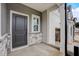 Welcoming front porch with a gray door, stylish stone accents, and covered entryway at 2003 Regal Dr # 90, Durham, NC 27703