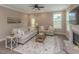 Cozy living room featuring neutral tones, a ceiling fan, a fireplace, and large windows for plenty of natural light at 2059 Dowell Ct, Burlington, NC 27215