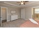 Bedroom featuring neutral paint, tray ceiling, carpeted floor, and an open view of the ensuite bath and walk-in closet at 2059 Dowell Ct, Burlington, NC 27215