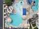 Aerial view of the pool area with a slide, water features, umbrellas, and lounge chairs at 2059 Dowell Ct, Burlington, NC 27215