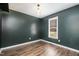 Cozy bedroom featuring a simple light fixture, a window, and hard wood-look flooring at 2120 Canterbury Rd, Clayton, NC 27520