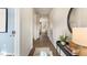 Hallway featuring wood floors, art, and decorative console table with mirror at 22 Black Creek Dr, Lillington, NC 27546