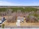Aerial view of a beautiful home nestled among trees, showcasing its expansive lot at 2233 Kanata Mills Rd, Wake Forest, NC 27587