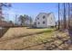 Exterior rear view of the home with a large backyard and a fenced perimeter at 2233 Kanata Mills Rd, Wake Forest, NC 27587