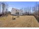 Rear view of the home showcasing a covered porch and a well-maintained backyard at 2233 Kanata Mills Rd, Wake Forest, NC 27587