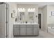 Bathroom with dual vanities, framed mirrors, and ample counter space at 2233 Kanata Mills Rd, Wake Forest, NC 27587