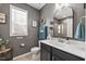 Well-lit bathroom featuring a large vanity, modern fixtures, and a window with natural light at 2233 Kanata Mills Rd, Wake Forest, NC 27587