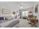 Cozy bedroom with ample natural light, a comfortable bed, and a charming study area at 2233 Kanata Mills Rd, Wake Forest, NC 27587
