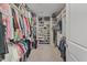 Spacious walk-in closet featuring shelving and hanging storage for clothes and shoes at 2233 Kanata Mills Rd, Wake Forest, NC 27587