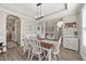 Traditional dining room featuring classic white chairs, wood floors, bright natural light and tray ceiling at 2233 Kanata Mills Rd, Wake Forest, NC 27587