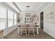 Traditional dining room featuring classic white chairs, wood floors, bright natural light and tray ceiling at 2233 Kanata Mills Rd, Wake Forest, NC 27587