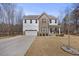 Inviting two-story home featuring mixed siding, well-manicured lawn, and attached two-car garage at 2233 Kanata Mills Rd, Wake Forest, NC 27587