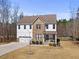 Charming two-story home featuring mixed siding, well-manicured lawn, and attached two-car garage at 2233 Kanata Mills Rd, Wake Forest, NC 27587