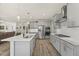 Open kitchen with stainless steel appliances, pendant lighting, and a large island with sink at 2233 Kanata Mills Rd, Wake Forest, NC 27587