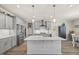 Spacious kitchen with gray cabinets, stainless steel appliances, and a large center island at 2233 Kanata Mills Rd, Wake Forest, NC 27587