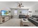 Bright living room featuring a ceiling fan, mounted TV, and comfortable seating at 2233 Kanata Mills Rd, Wake Forest, NC 27587