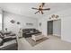 Comfortable living room featuring a ceiling fan, plush seating, and ample natural light at 2233 Kanata Mills Rd, Wake Forest, NC 27587