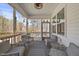 Relaxing screened porch with comfortable seating and natural light at 2233 Kanata Mills Rd, Wake Forest, NC 27587