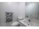 Well-lit half bathroom featuring a stylish towel and a pristine white vanity at 2404 Pearces Rd, Zebulon, NC 27597