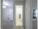 Bathroom featuring tile flooring, light fixture, and decorative towel hanging on the door at 2404 Pearces Rd, Zebulon, NC 27597