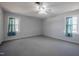 Bedroom with two windows, ceiling fan, and carpeting at 2404 Pearces Rd, Zebulon, NC 27597