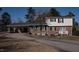 Two-story brick home with a carport and lush surroundings at 2404 Pearces Rd, Zebulon, NC 27597