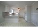 Well-lit kitchen with white cabinetry, tile flooring, and ceiling fan at 2404 Pearces Rd, Zebulon, NC 27597