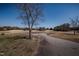Scenic property with a paved road, mature trees, and views of the golf course at 2404 Pearces Rd, Zebulon, NC 27597