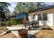 Charming backyard patio with outdoor dining set, perfect for enjoying meals and entertaining guests at 2409 Keith Dr, Raleigh, NC 27610