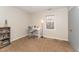 Bright bedroom featuring a desk, window, and shelving unit for storage or displaying decor at 2409 Keith Dr, Raleigh, NC 27610