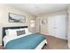 Comfortable bedroom featuring carpeted floors, a queen bed, and access to a bathroom at 2409 Keith Dr, Raleigh, NC 27610