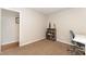 Cozy bedroom with neutral walls, carpet, shelving for storage, and study space at 2409 Keith Dr, Raleigh, NC 27610