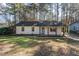 Charming single-story home with a brick facade, blue door, and covered front porch at 2409 Keith Dr, Raleigh, NC 27610