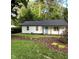 Charming home with a well-manicured lawn and a bright blue front door at 2409 Keith Dr, Raleigh, NC 27610