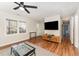 Bright living room with hardwood floors, natural light, and a modern entertainment center at 2409 Keith Dr, Raleigh, NC 27610