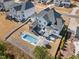Aerial view of the home's backyard featuring pool, hot tub, outdoor seating, and patio area at 2632 Jordan Pointe Blvd, New Hill, NC 27562