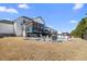 Expansive backyard featuring a pool, covered patio, and ample space for outdoor enjoyment at 2632 Jordan Pointe Blvd, New Hill, NC 27562