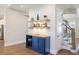 Stylish bar area featuring custom cabinets, countertop, decor and bar stool with easy access to the staircase at 2632 Jordan Pointe Blvd, New Hill, NC 27562