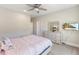 Neutral bedroom with a comfy bed, large window, and dresser, perfect for relaxing and unwinding at 2632 Jordan Pointe Blvd, New Hill, NC 27562