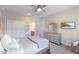 Comfortable bedroom with a ceiling fan, double closet, and dresser beneath a decorative mirror at 2632 Jordan Pointe Blvd, New Hill, NC 27562