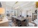 Bright dining room showcasing hardwood floors, a modern chandelier, and large windows at 2632 Jordan Pointe Blvd, New Hill, NC 27562