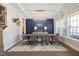 Elegant dining room with coffered ceilings, modern chandelier, and designer accent wall at 2632 Jordan Pointe Blvd, New Hill, NC 27562