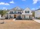 Charming two-story home boasting a well-manicured lawn, stone accents and inviting curb appeal at 2632 Jordan Pointe Blvd, New Hill, NC 27562