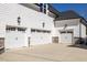 Spacious three-car garage featuring stylish carriage doors and stone accents for added curb appeal at 2632 Jordan Pointe Blvd, New Hill, NC 27562
