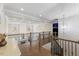 Elegant hallway with coffered ceiling, hardwood floors, and iron-railed staircase leading to the lower level at 2632 Jordan Pointe Blvd, New Hill, NC 27562